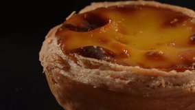 Rotating popular Portuguese custard tart - Pastel De Nata. Close up and detail macro shot.