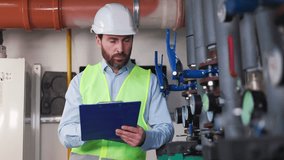 Business manager, mechanic, engineer, plumber holds a tablet and makes notes, recording water meter readings. The factory worker analyzes data, located in the boiler room of a commercial building. - Powered by Shutterstock - Get 15% off with code: PIKWIZARD15