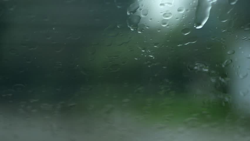 Autumn raindrops hit the window, streaming down with wipers in slow-motion clearing the view sporadically. | Shutterstock HD Video #1111664887