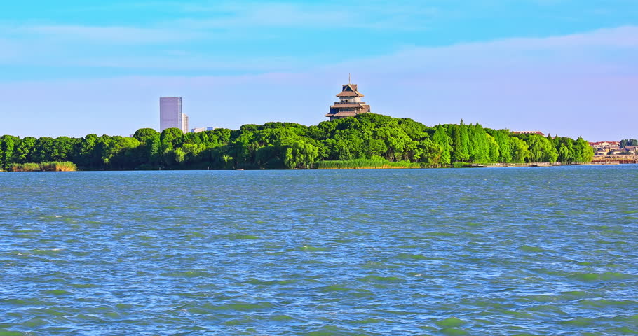 Clear lake water and green forest with pavilion scenery in Suzhou, Jiangsu Province, China. Panoramic view.