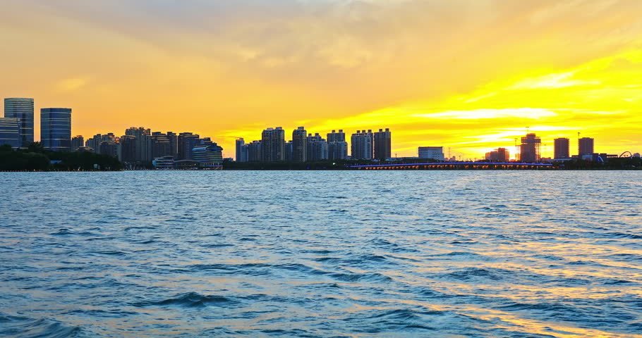Suzhou skyline and modern buildings scenery at sunset by the lake, Jiangsu Province, China. Beautiful Jinji Lake landscape in Suzhou.