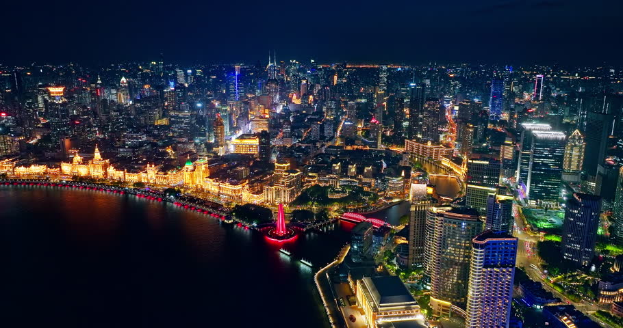 Aerial footage of city skyline and modern building scenery at night in Shanghai, China. Famous modern buildings on the Bund in Shanghai.