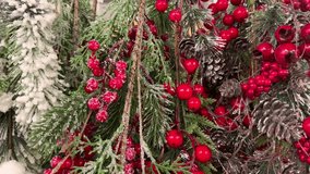 Christmas background with red berries and green fir branches with cones covered with frost. Snow covered red berries, green fir branches and pine cones in snow close up. Christmas decorations - Powered by Shutterstock - Get 15% off with code: PIKWIZARD15