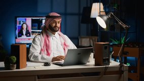 Arab job candidate remotely being interviewed by human resources team while at home. Muslim man getting his credentials checked during online video conference meeting before being employed