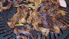 Barbeque meat grilled on grill pan. Cooking using food tongs