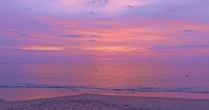 
time lapse amazing sweet sky above Karon beach Phuket at colorful sunset.
beautiful scene with the sun painting the sky above waves 
breaking gently on a sandy
Gradient sweet color. abstract nature