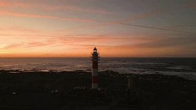 Beautiful sunset behind the historic Faro del Toston traditional lighthouse near El Cotillo and Corralejo in Fuerteventura Canary Islands Spain