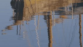 Reflections of Old Wooden Boats in calm Sea in Daylight - Background B Roll 4K Video