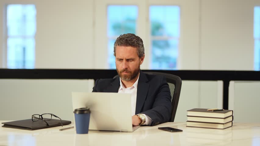 Office worker with laptop at office. Ofice employee remote working in modern office. Businessman have on line meeting. Business man using computer in office. Modern offices workplace.