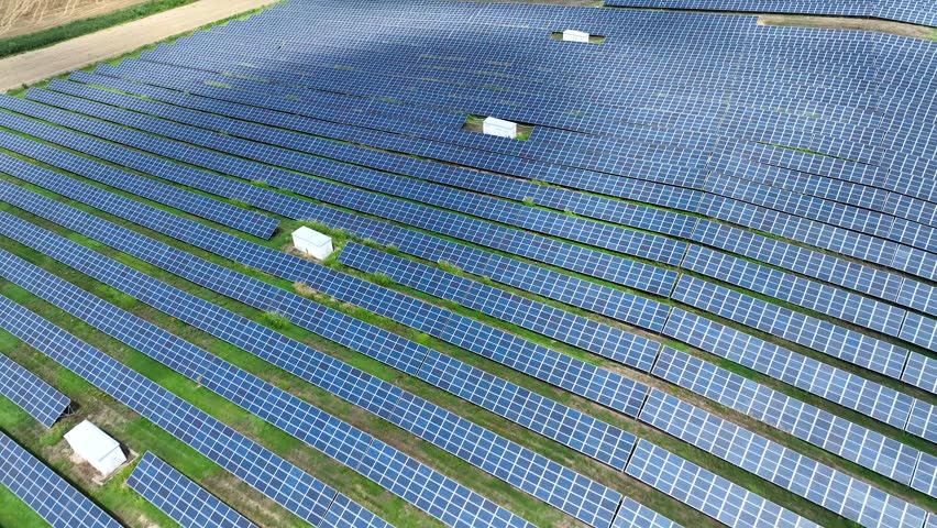 Aerial Drone view of Blue Solar panel farm or solar power plant. Alternative renewable energy with photovoltaic cell industry. Green energy technology for future concept in Germany | Shutterstock HD Video #1111694605
