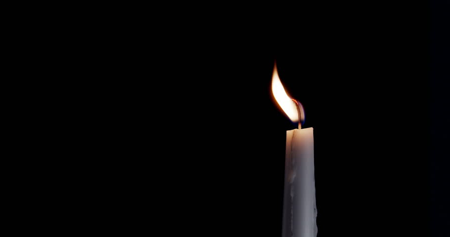 A single white candle burning. Isolated candle slow motion burning with dark background. White paraffin candle with yellow shades burns on a black background. Slow motion. | Shutterstock HD Video #1111695055