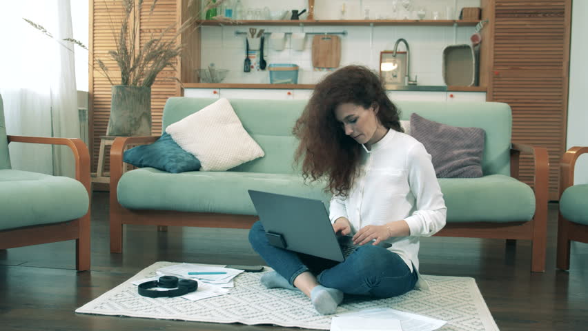 Gorgeous woman is working on a computer from home. Workimg from home during coronavirus pandemic. | Shutterstock HD Video #1111701815