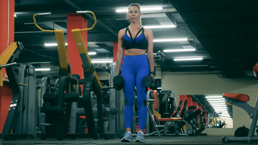 Sportswoman does crossfit, squatting with dumbbells. | Shutterstock HD Video #1111701847