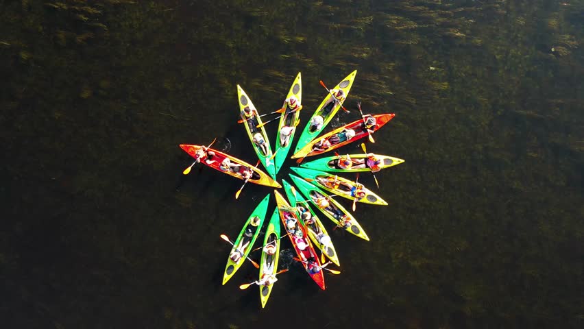 Spectacular aerial view of kayaks forming a star pattern form on a river