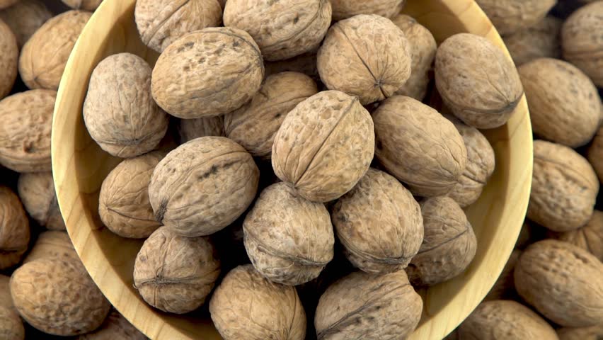 Walnut in shell. Background view from above. Healthy food bowl top view | Shutterstock HD Video #1111711153
