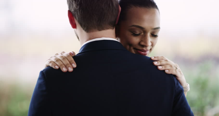 Couple, love and dancing at wedding, romance and celebration for partnership, commitment and union. Interracial, marriage and hug or support, husband and wife at event, care and trust in outdoors Royalty-Free Stock Footage #1111712047