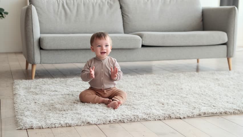 Little Child Sitting on the Rug and Clapping Hands | Shutterstock HD Video #1111715137