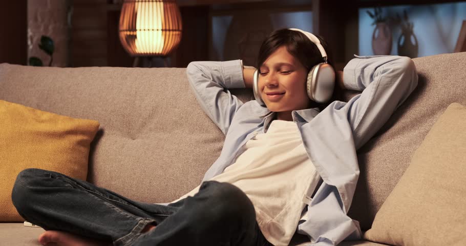Boy Listening to Music in Headphones in the Living Room | Shutterstock HD Video #1111715151