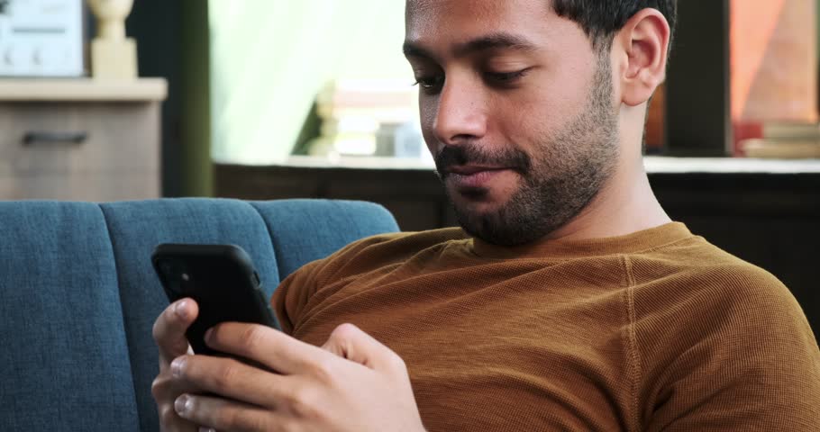 Middle Eastern Man Using Phone on Sofa in the Living Room | Shutterstock HD Video #1111715173