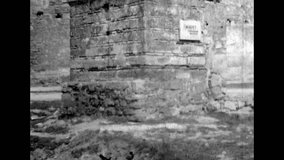 Medieval castle tower, fortifications on sky background. Panorama view from bottom to top. Brick defensive historical building. Archival vintage black white film. Overscan retro archive. 1980s Crimea