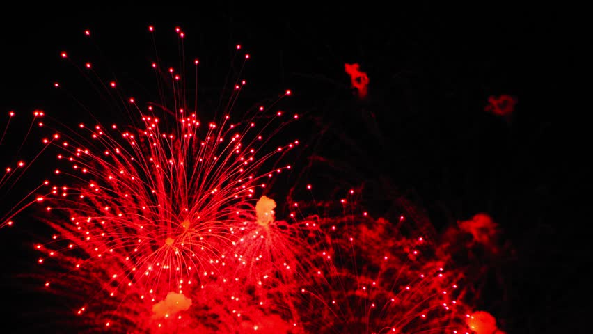 Golden and fiery red colors of fireworks flash on the black night sky | Shutterstock HD Video #1111719675