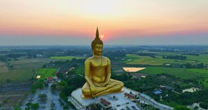 
aerial view The sun was above the head of the biggest golden Buddha at sunset.
landmark of Buddhism in Thailand.
video 4K Nature video High quality footage for worship and travel concep