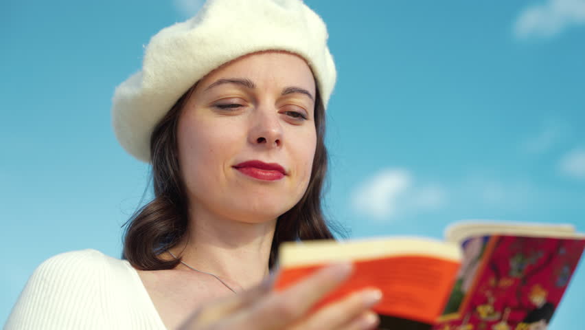 Smiling girl with a book in the Tuileries garden in Paris | Shutterstock HD Video #1111722657