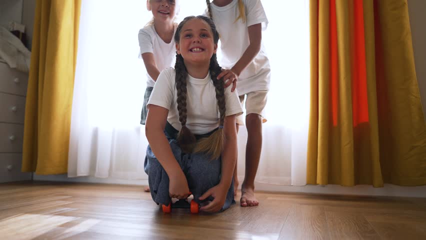 Happy family. group of children play with skateboard at home. kids in kindergarten learn to skateboard.Children play on floor at home.Happy children play happily together in kindergarten.games at home | Shutterstock HD Video #1111723529