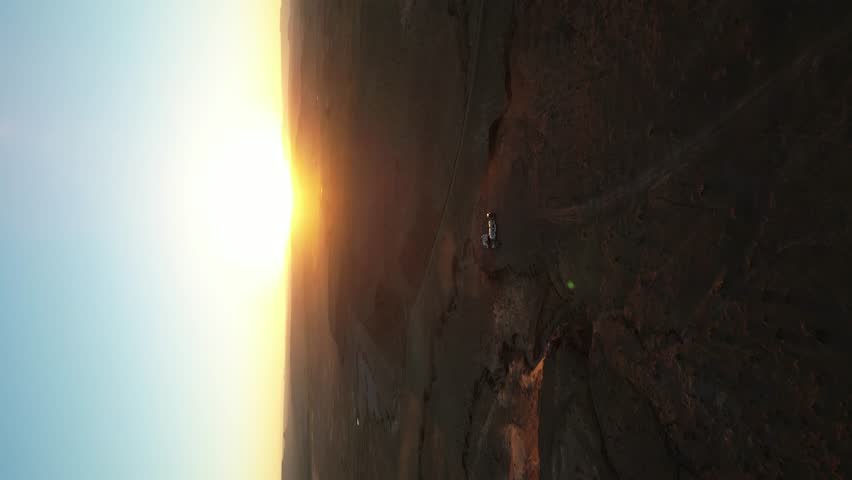 Vertical high aerial of motor homes camped in Moab Utah desert at sunset