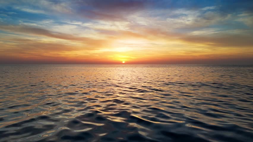 Epic sunset over the sea or ocean. Flying above water surface at red sunset sky. Sun reflect in the sea, aerial drone shot | Shutterstock HD Video #1111726469
