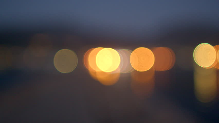 City lights in bokeh. Dark Holiday background. Play of lights, creating a dynamic and visually captivating atmosphere. Depth and aesthetic appeal to the festive setting. | Shutterstock HD Video #1111727789