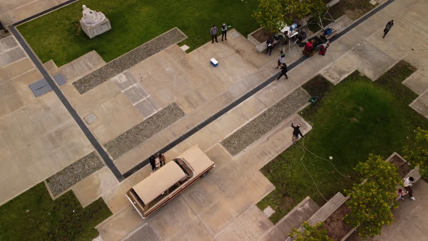 Top view, film crew working on the outdoor set, preparing for filming