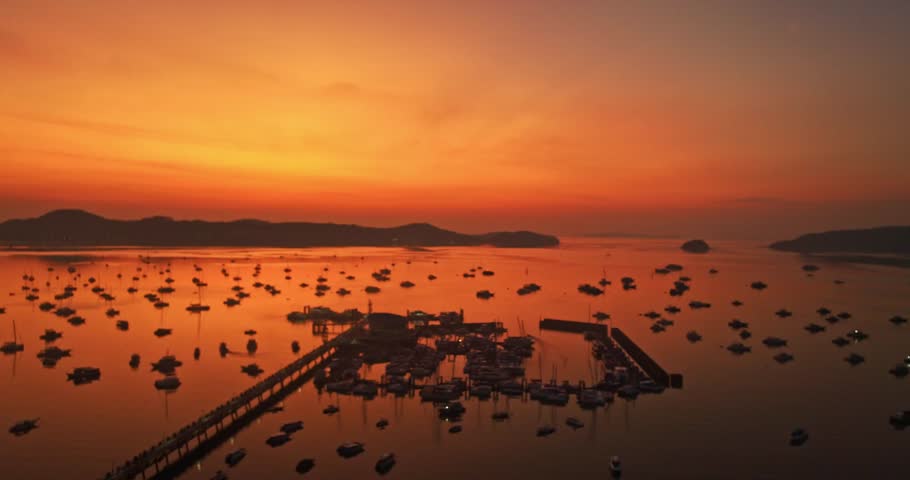 
aerial view scenery red cloud in sky of twilight over Chalong pier.
beautiful sunrise landscape amazing light of nature sky over horizon.
colorful sky sunrise background.
