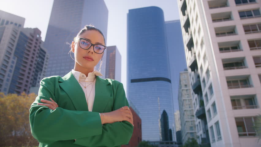 Stylish lady boss female leader woman in formal shirt posing crossing arms looking at camera in corporate worker. Millennial 20s successful confident strong businesswoman standing outdoors in downtown
