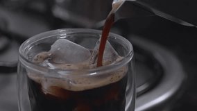 Pour fresh espresso into a glass with ice cubes. Fresh ice coffee, espresso, with thick, soft crema foam to mix with water to make an Americano. Brew coffee from Arabica and Robusta beans. - Powered by Shutterstock - Get 15% off with code: PIKWIZARD15