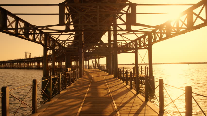 Muelle de Rio Tinto in Huelva, Andalucia, Spain at night, with stunning lights, reflecting in dark waters of the flowing Odiel River
