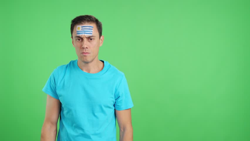 Dignified and serious man with uruguayan flag painted on face