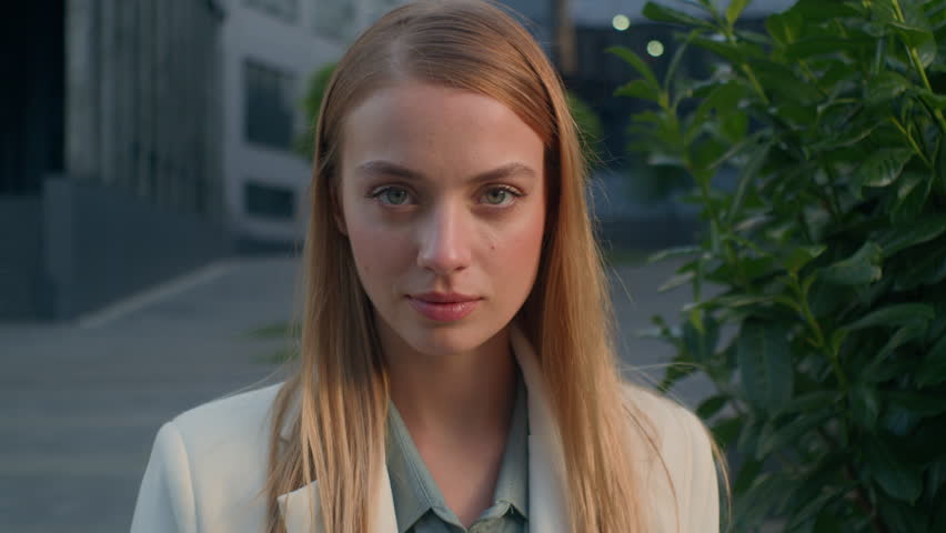Serious successful confident caucasian beautiful woman girl businesswoman entrepreneur leader professional manager business lady looking at camera posing near office building female portrait outdoors | Shutterstock HD Video #1111751075