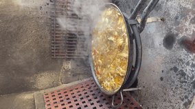 Video cooking Valencian paella in vertical format. Recorded in Spain