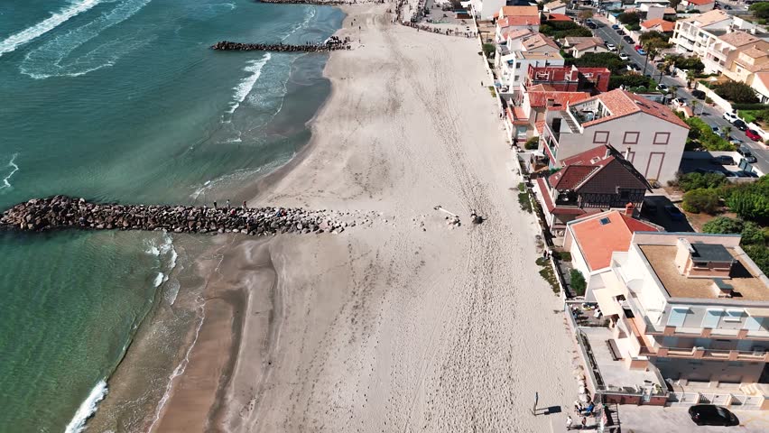 Riders riding horses in Palavas les Flots, on the Mediterranean coast of France on a sunny day, aerial view with a drone | Shutterstock HD Video #1111752947