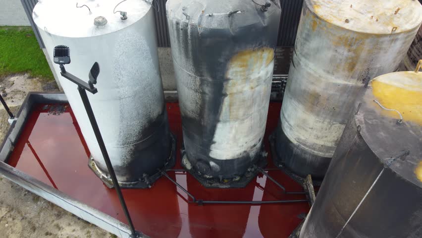 Aerial view over burnt industrial containers, extinguished fire of hazardous materials | Shutterstock HD Video #1111752979