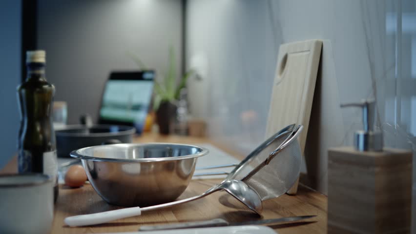 Home kitchen with cooking staf on table ready for preparing delicious food at weekend with some movie at the background. | Shutterstock HD Video #1111755971