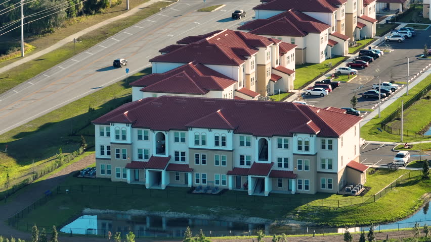 Aerial view of American apartment buildings in Florida residential area. New family condos as example of housing development in US suburbs | Shutterstock HD Video #1111756745