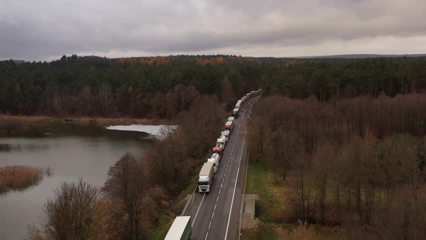a queue of trucks waiting to cross the Polish-Ukrainian border - view from a drone Royalty-Free Stock Footage #1111758297