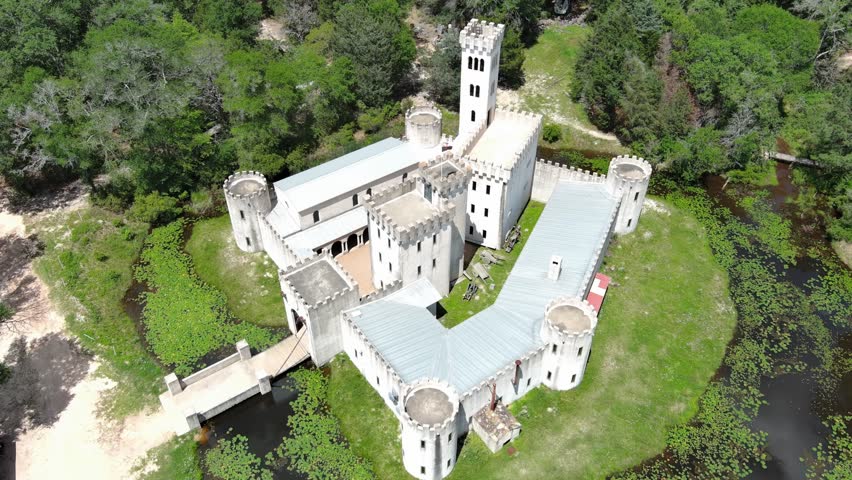 Castle. Drone flying over the castle. The castle is located on the shore of a lake in the forest.