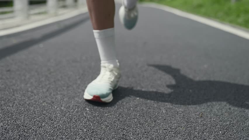 Close-up shot of legs and feet of a woman running jogging | Shutterstock HD Video #1111760999