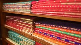 Handmade Indian silk sari or Banarasi saree with beautiful texture and hand work on it placed together in store for showcase. - Powered by Shutterstock - Get 15% off with code: PIKWIZARD15