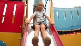 Happy family concept.child plays on playground in park. baby rides down slide. entertaining and relaxing the child on weekends. active outdoor recreation in the park. baby on a slide on the playground - Powered by Shutterstock - Get 15% off with code: PIKWIZARD15