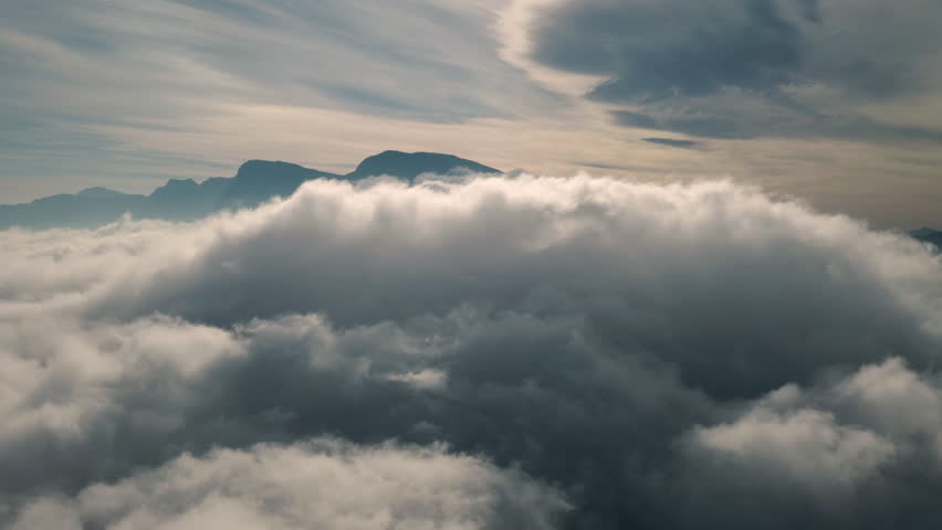 Aerial drone, sky and clouds on mountain of nature, heaven or new dawn in mysterious land. Serene, calm or peaceful cloudy mist of magical, hope or natural scenery on earth, weather or outdoor view | Shutterstock HD Video #1111766859