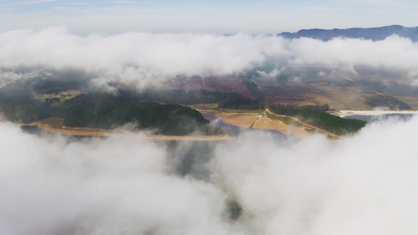 Aerial drone, clouds and mountain with land in heaven with blue sky above, nature or new dawn of mysterious land. Top view of serene, calm or peaceful cloudy mist of magical, hope or natural weather | Shutterstock HD Video #1111766961